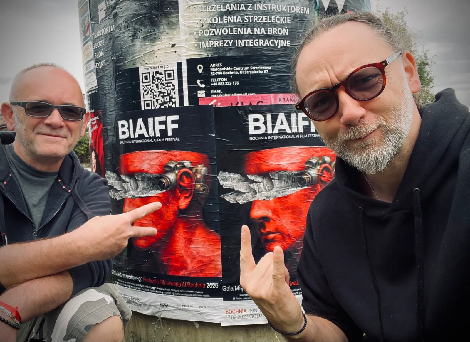Two guests taking a selfie in front of BIAIFF posters